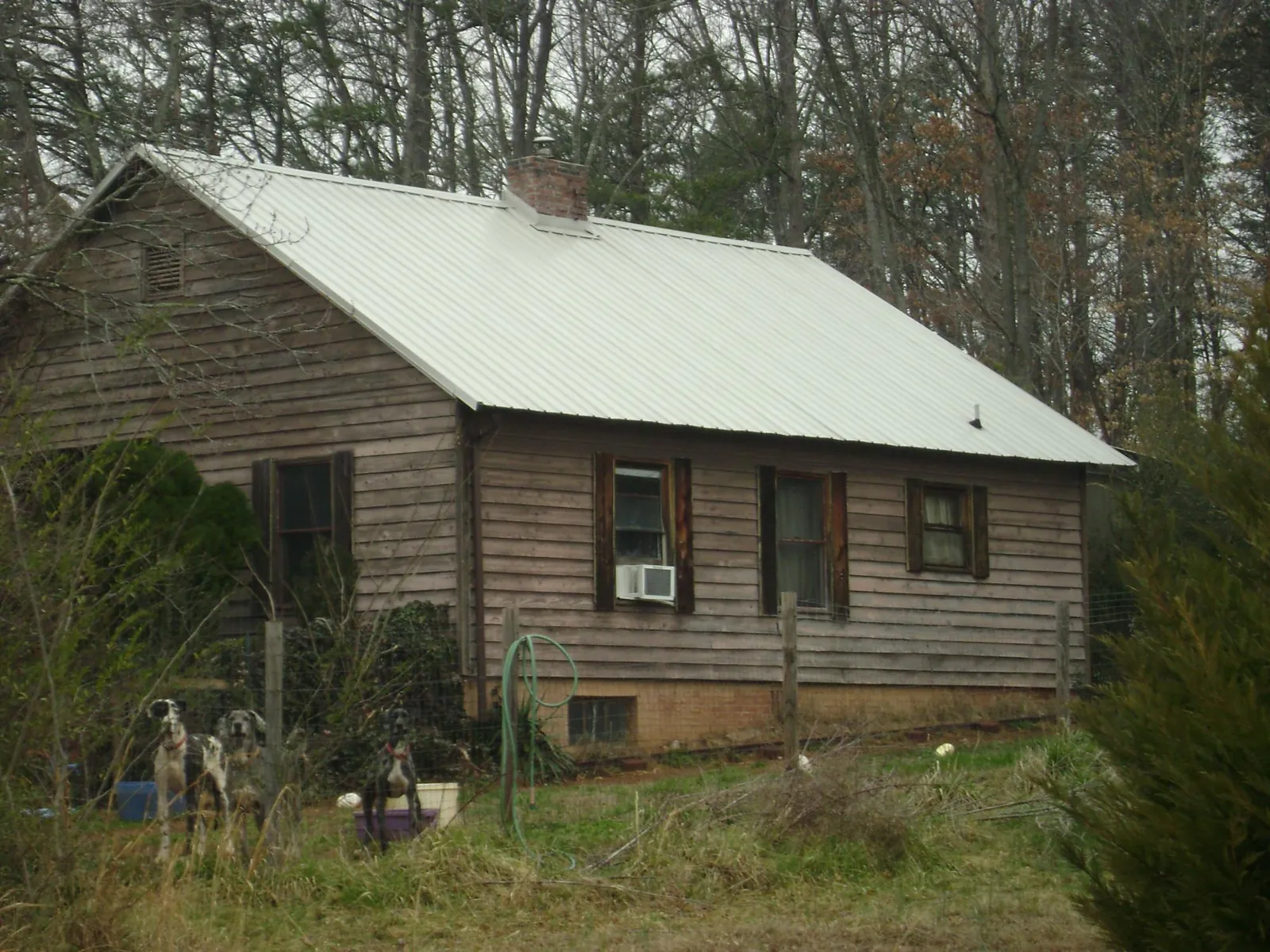 White metal roof on an old wood sided farmhouse, from a Metal Roof Installation job in Blue Mound